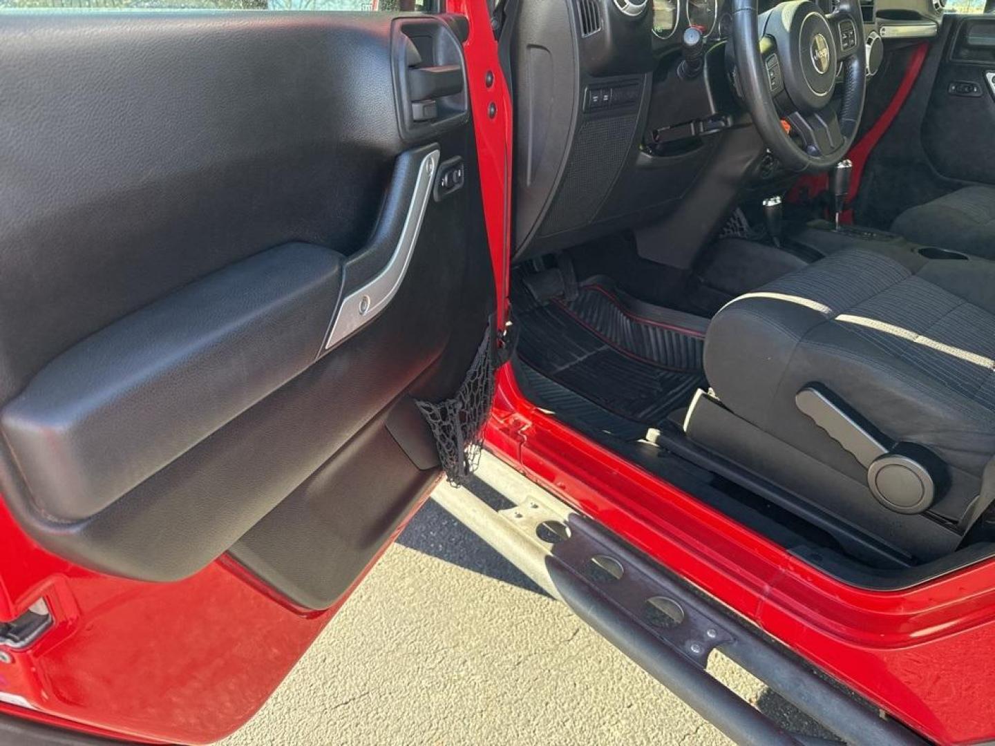 2011 RED /BLACK Jeep Wrangler Rubicon (1J4BA6D11BL) with an V6, 3.8L engine, Automatic transmission, located at 10890 W. Colfax Ave., Lakewood, CO, 80215, (303) 274-7692, 39.739914, -105.120132 - Get ready for adventure with this 2011 Jeep Wrangler Rubicon, a true icon of off-road prowess and rugged style. This trail-ready beast is equipped with a robust 4WD system and a powerful V6, 3.8L engine that promises an exhilarating drive, whether you're navigating city streets or tackling rugged tr - Photo#55